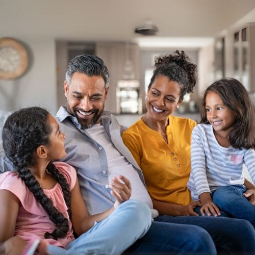 Happy family smiling at each other